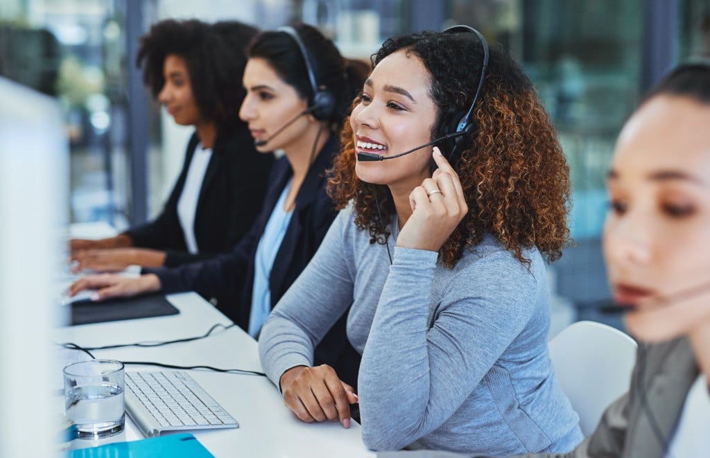 People chatting and looking at a computer